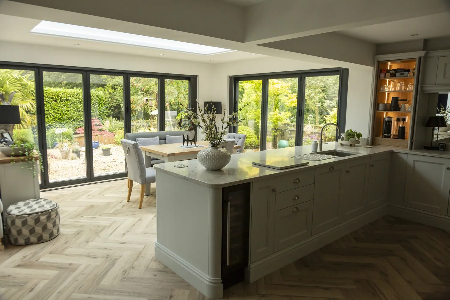 Open-plan kitchen extension with an island and bifold doors