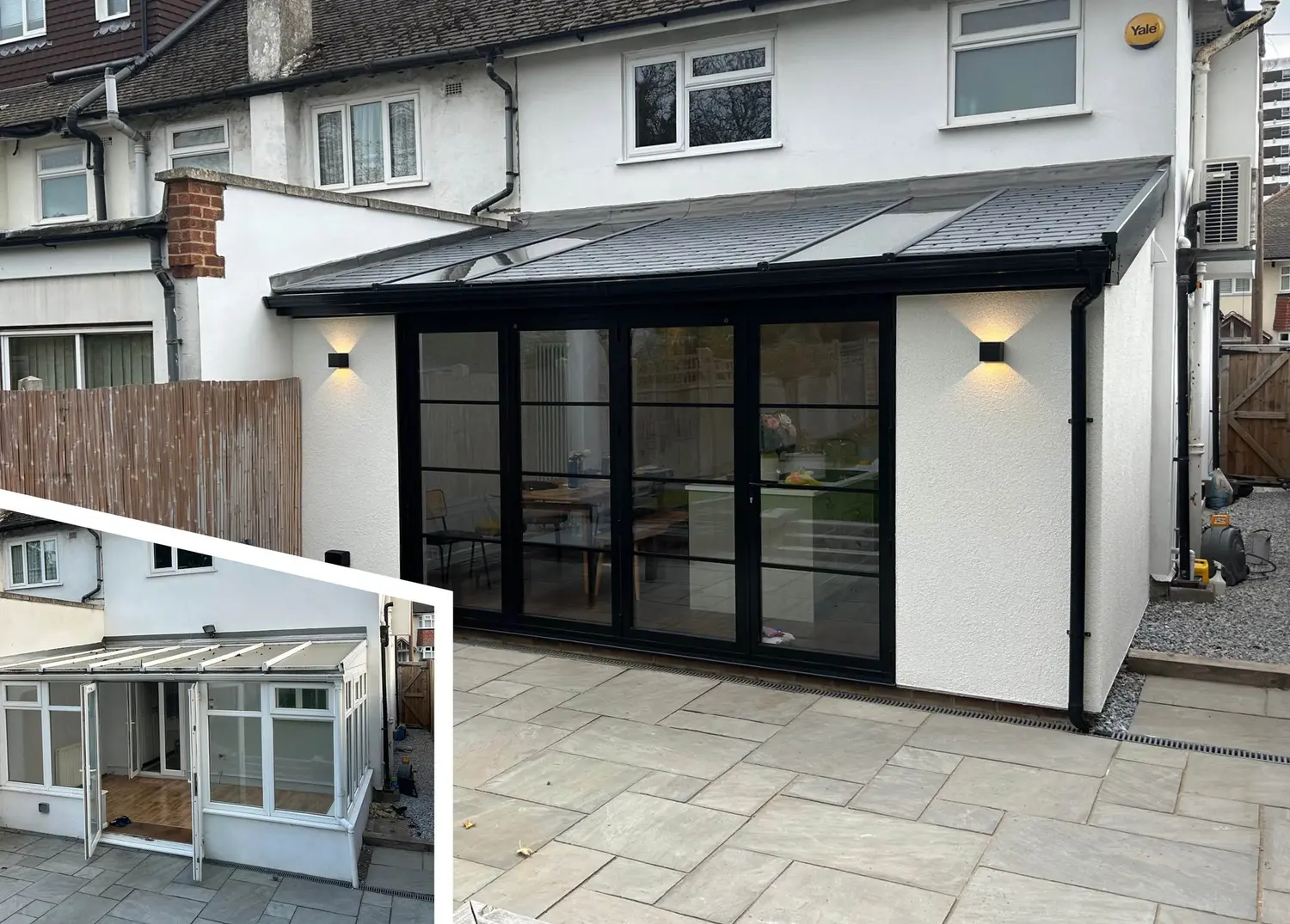 A dark-framed multi-panel glazed door run on a rendered lean-to extension, with a single opening door within the run