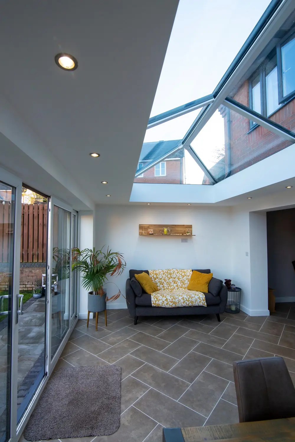 A single-storey extension with a roof lantern and sliding patio doors onto a terrace