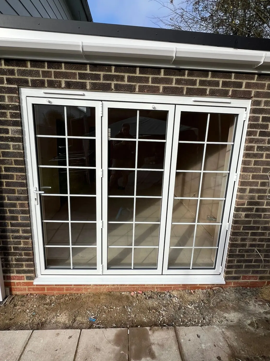 White UPVC French doors with Georgian bars, opening onto a patio